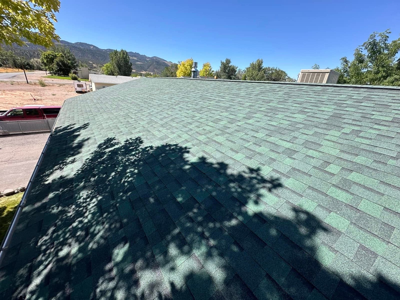 Close view of a finished architectural shingle roof with mountain views in Southern Utah
