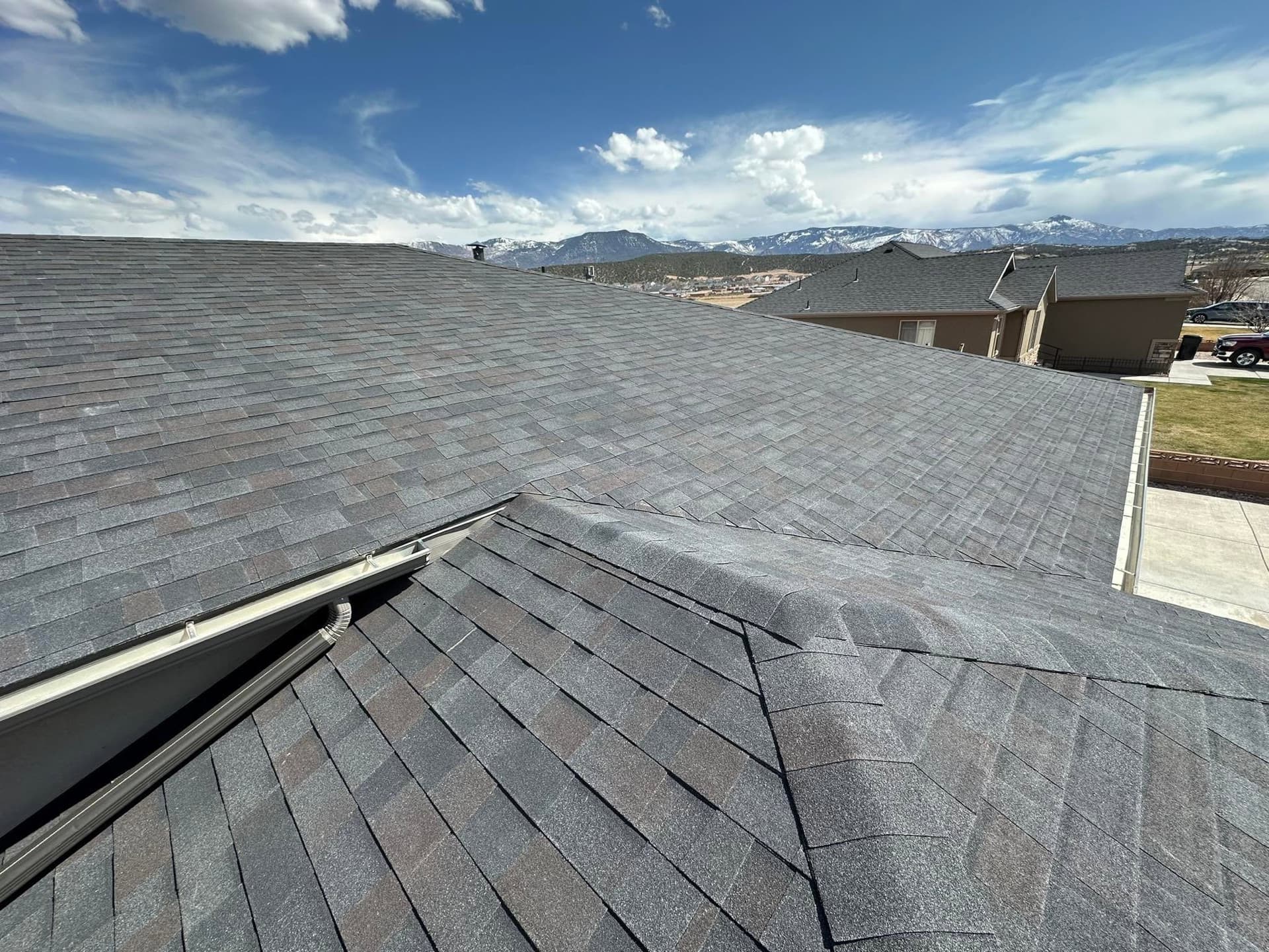 A completed Cardona Company roof on a Cedar City home at sunset